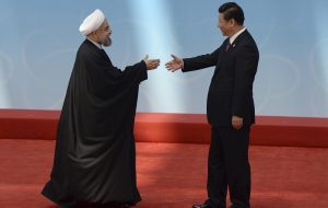 Iran’s President Rouhani shakes hands with his Chinese counterpart Xi before the opening ceremony of the CICA summit in Shanghai