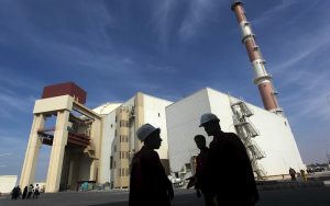 File photo of Iranian workers standing in front of Bushehr nuclear power plant