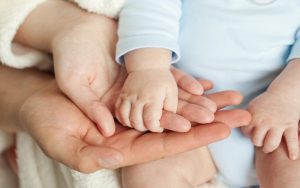Mom,And,Dad,Hold,Baby’s,Hand