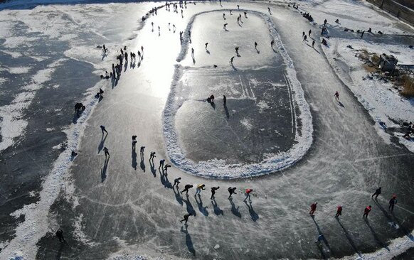 اسکیت بازان روی یخ در تالاب های یخ زده اطراف رودخانه "سونگوا" در هاربین چین، اسکیت می کنند.