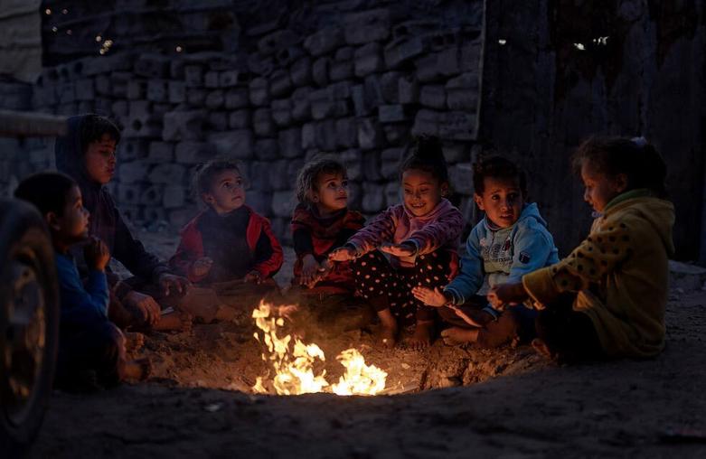 کودکان فلسطینی در حال گرم کردن خود